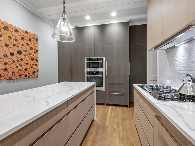 a kitchen with a sink stove and cabinets