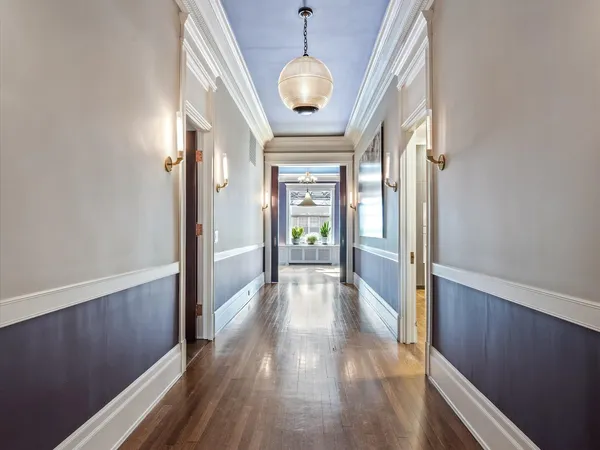 a view of a hallway view with wooden floor and staircase