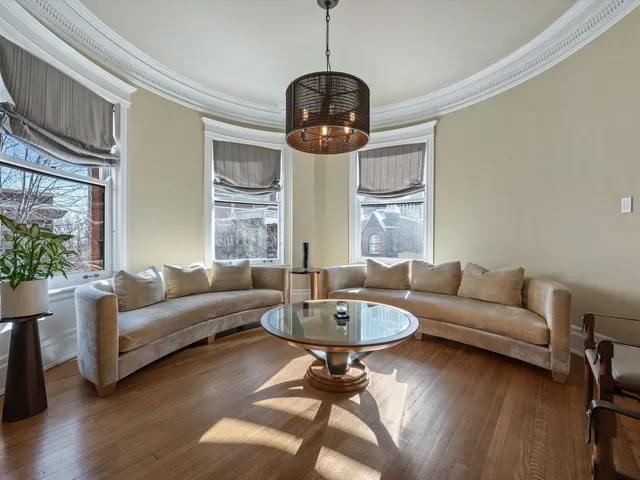 a living room with furniture a dining table and a window
