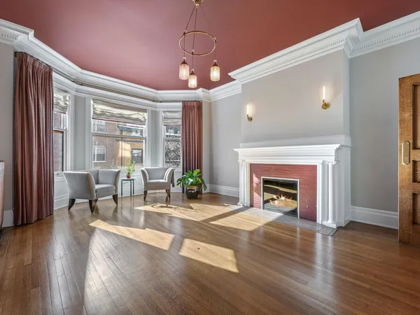 a living room with fireplace furniture and a wooden floor