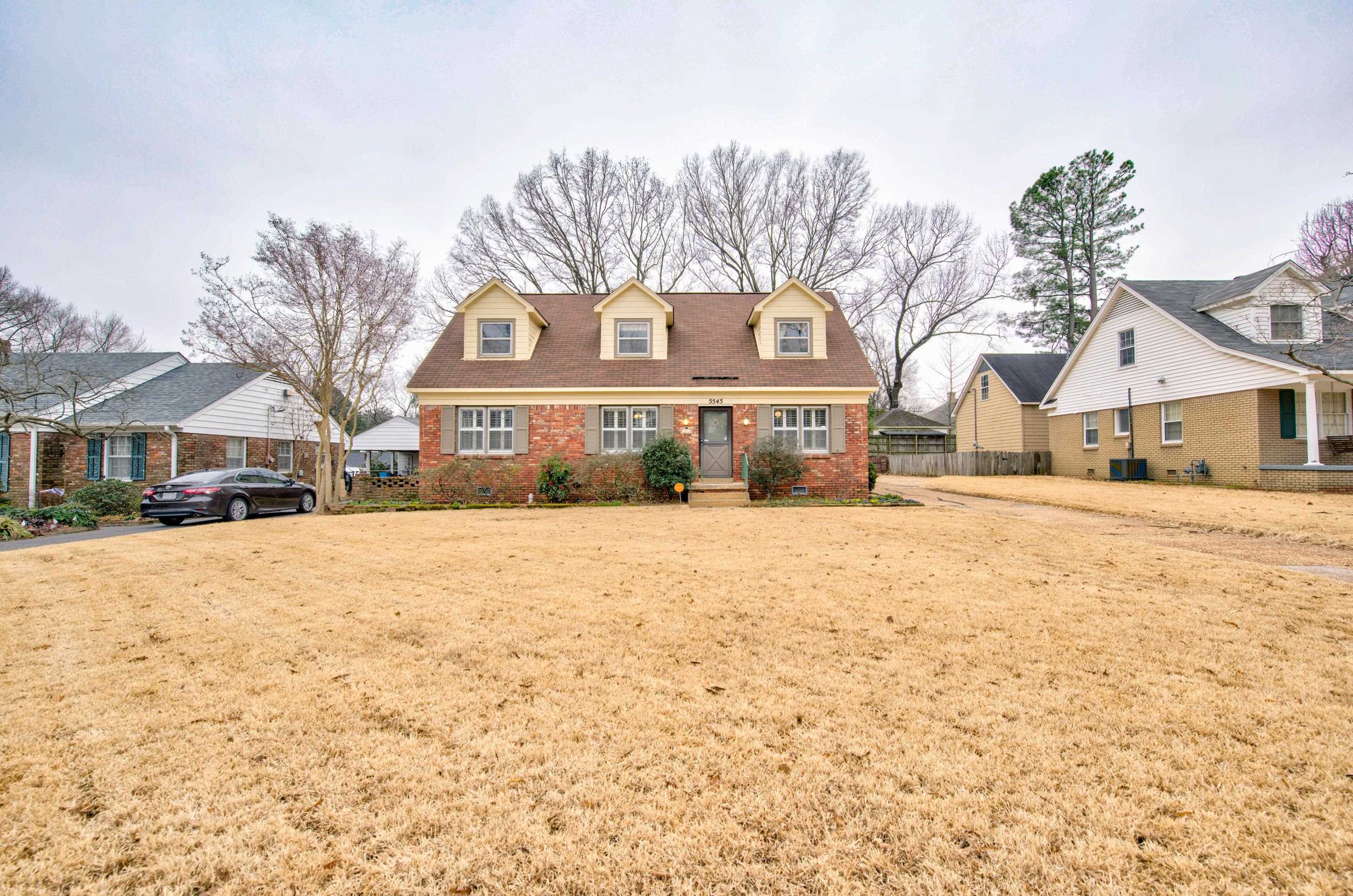 5545 Rich Road Memphis, TN 38120 - Photo 1 of 20 a front view of a house with a yard covered with snow