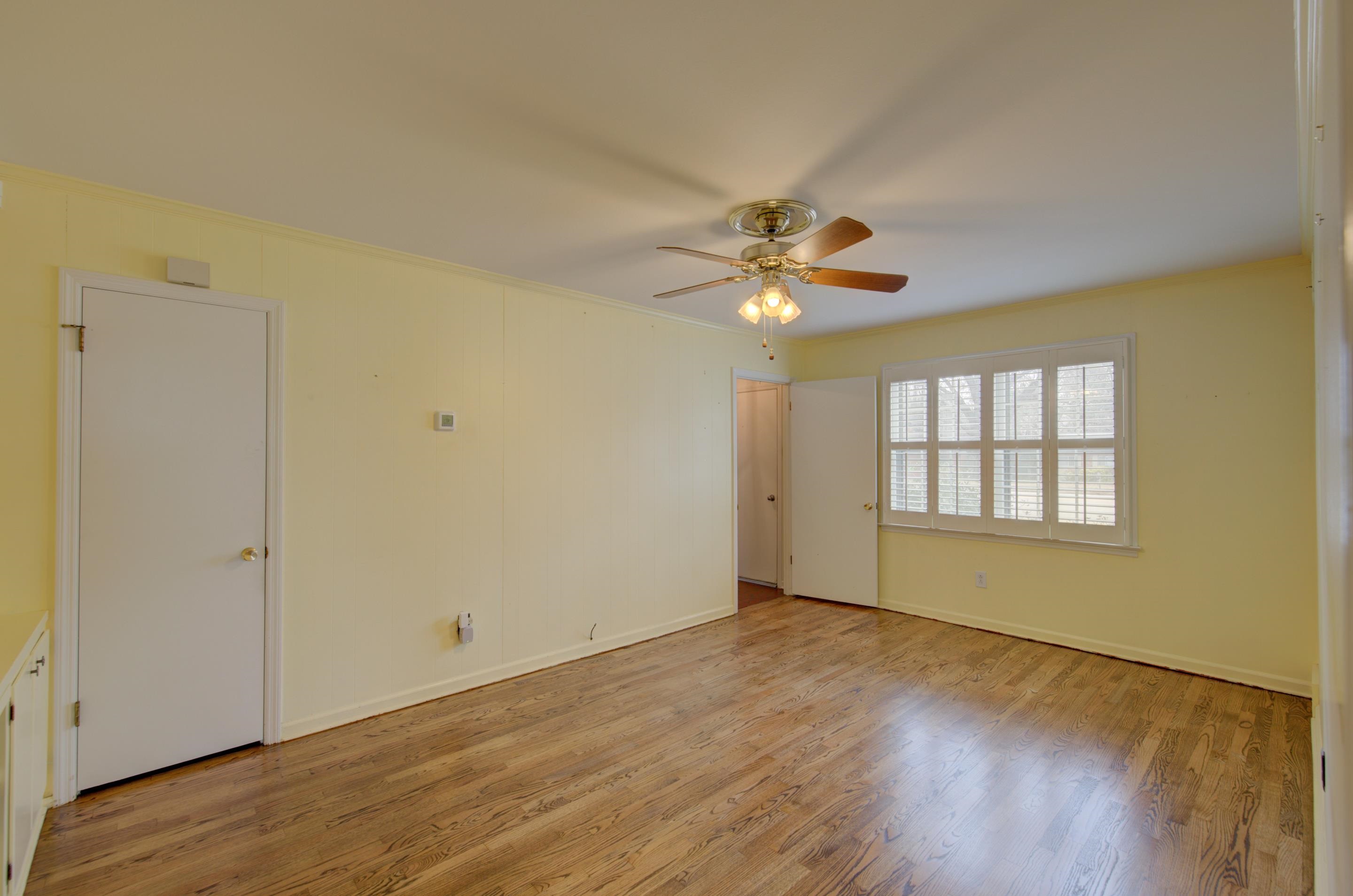 5545 Rich Road Memphis, TN 38120 - Photo 2 of 20 a view of an empty room with wooden floor and a window