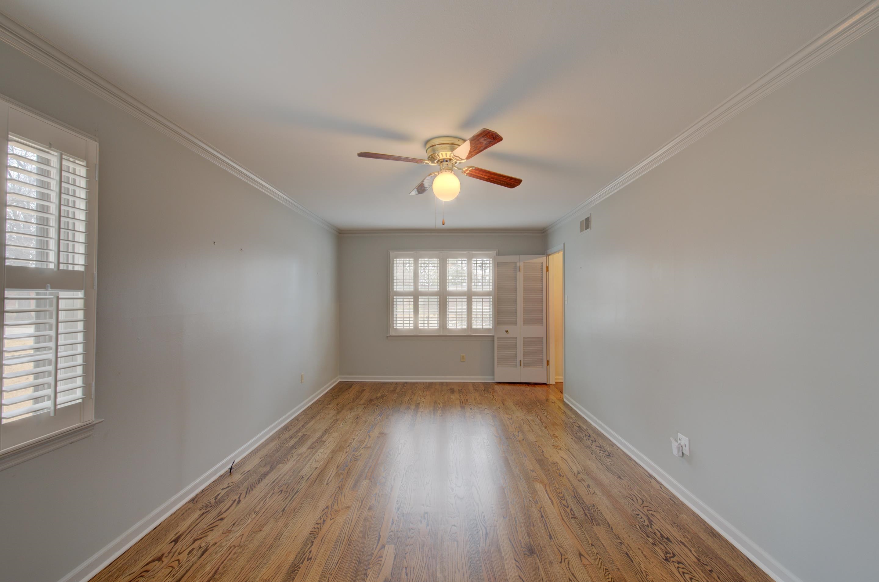 5545 Rich Road Memphis, TN 38120 - Photo 4 of 20 an empty room with wooden floor and windows