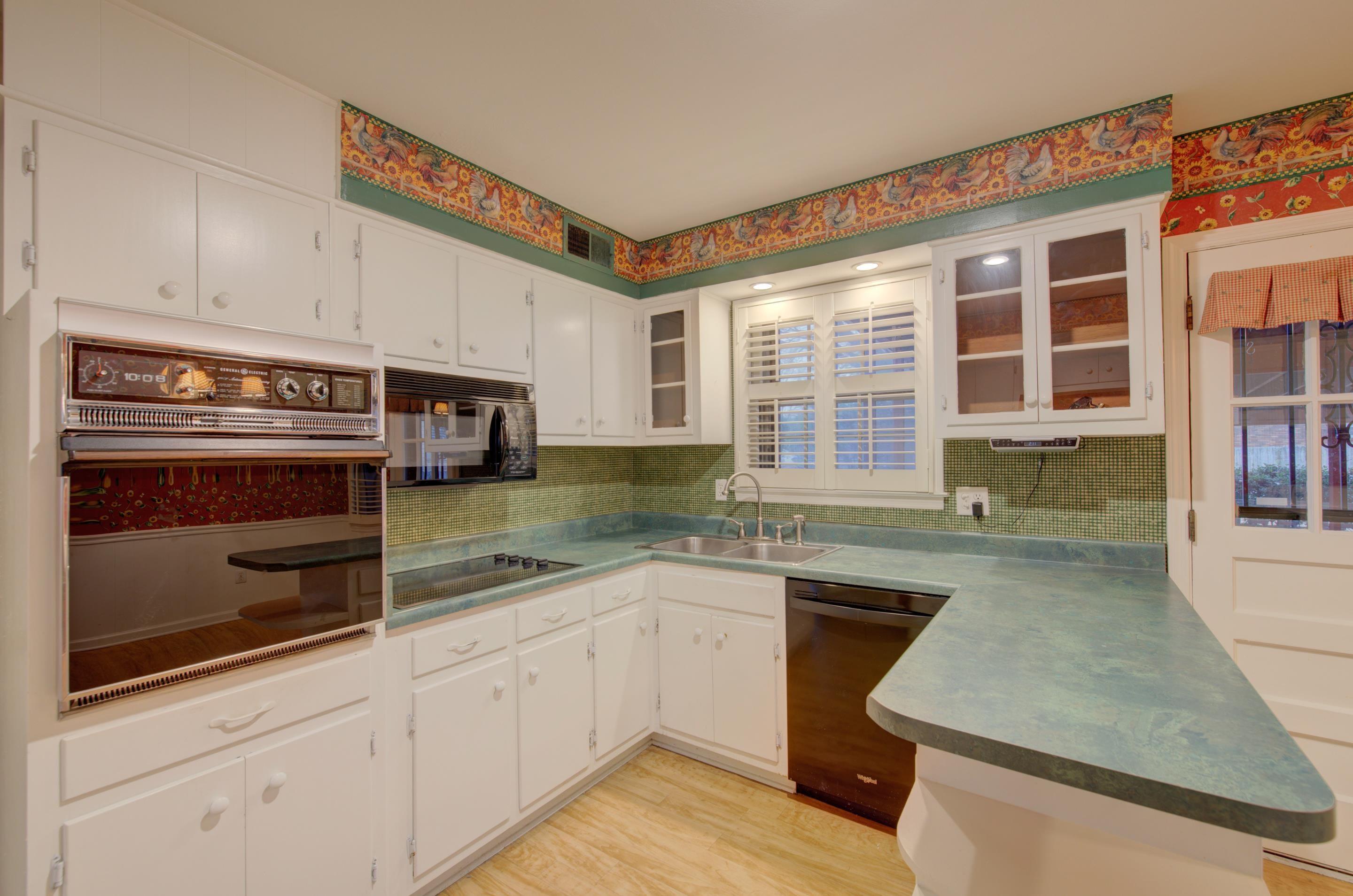 5545 Rich Road Memphis, TN 38120 - Photo 9 of 20 a kitchen with stainless steel appliances granite countertop a stove a sink and white cabinets