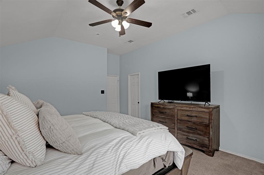 1005 Caleb Street Burleson, TX 76028 - Photo 13 of 31 a bedroom with a bed and a flat screen tv