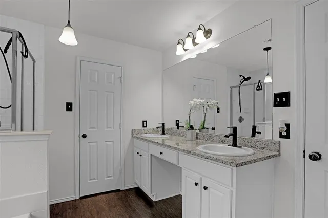 a bathroom with a sink a toilet a bathtub and shower