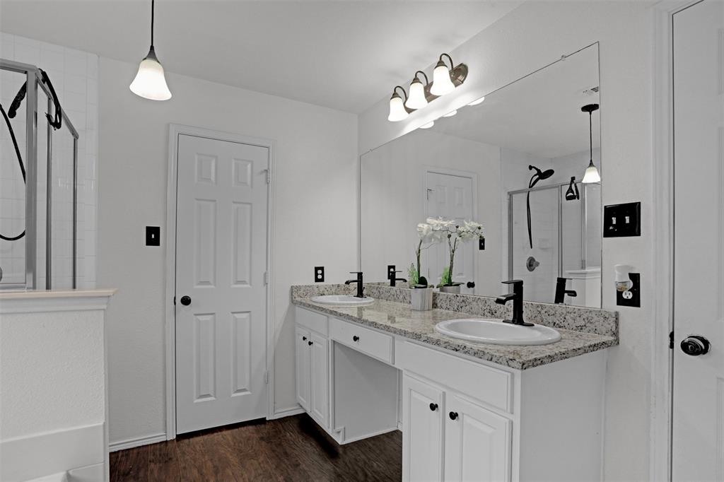 1005 Caleb Street Burleson, TX 76028 - Photo 15 of 31 a bathroom with a sink vanity and a mirror