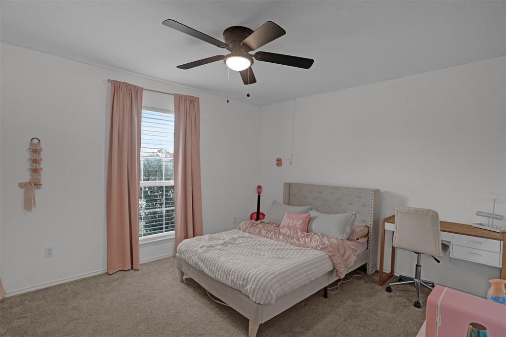 1005 Caleb Street Burleson, TX 76028 - Photo 17 of 31 a bedroom with a bed and a large window