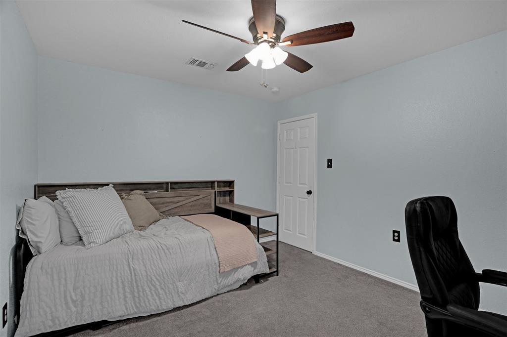 1005 Caleb Street Burleson, TX 76028 - Photo 21 of 31 a bedroom with a bed and a ceiling fan