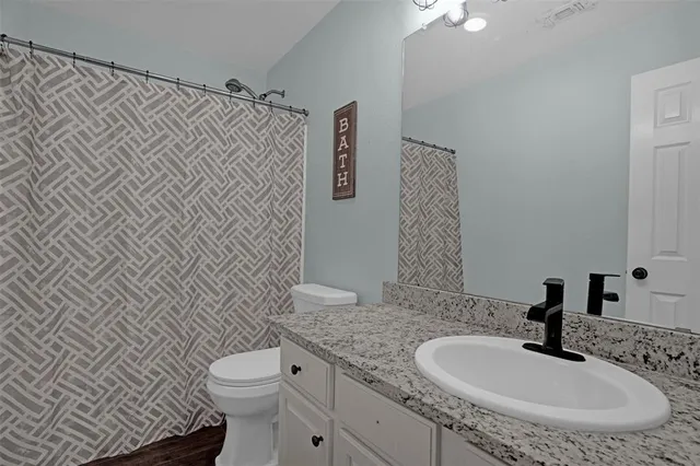 a bedroom with a bed and a ceiling fan