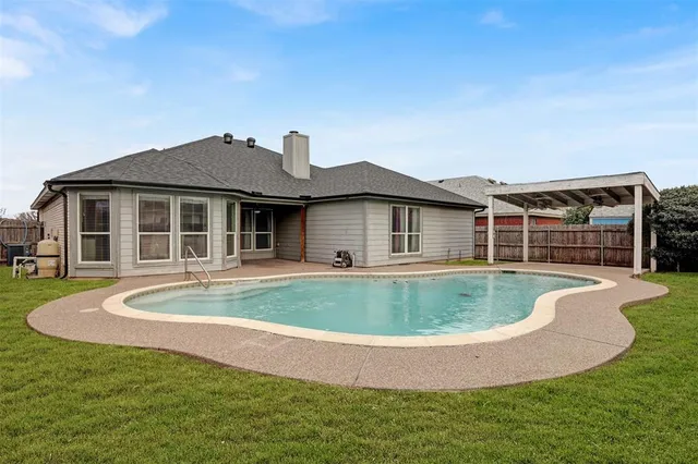 a view of a house with backyard sitting area and tub