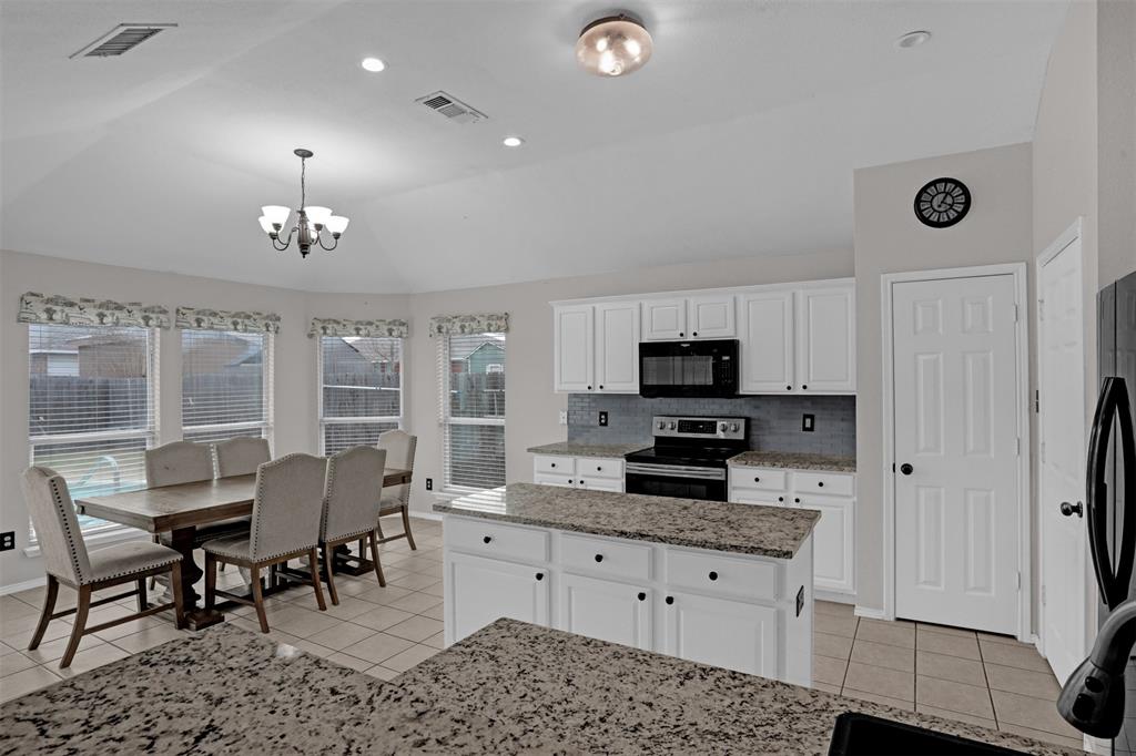 1005 Caleb Street Burleson, TX 76028 - Photo 7 of 31 a living room with furniture a fireplace and a flat screen tv