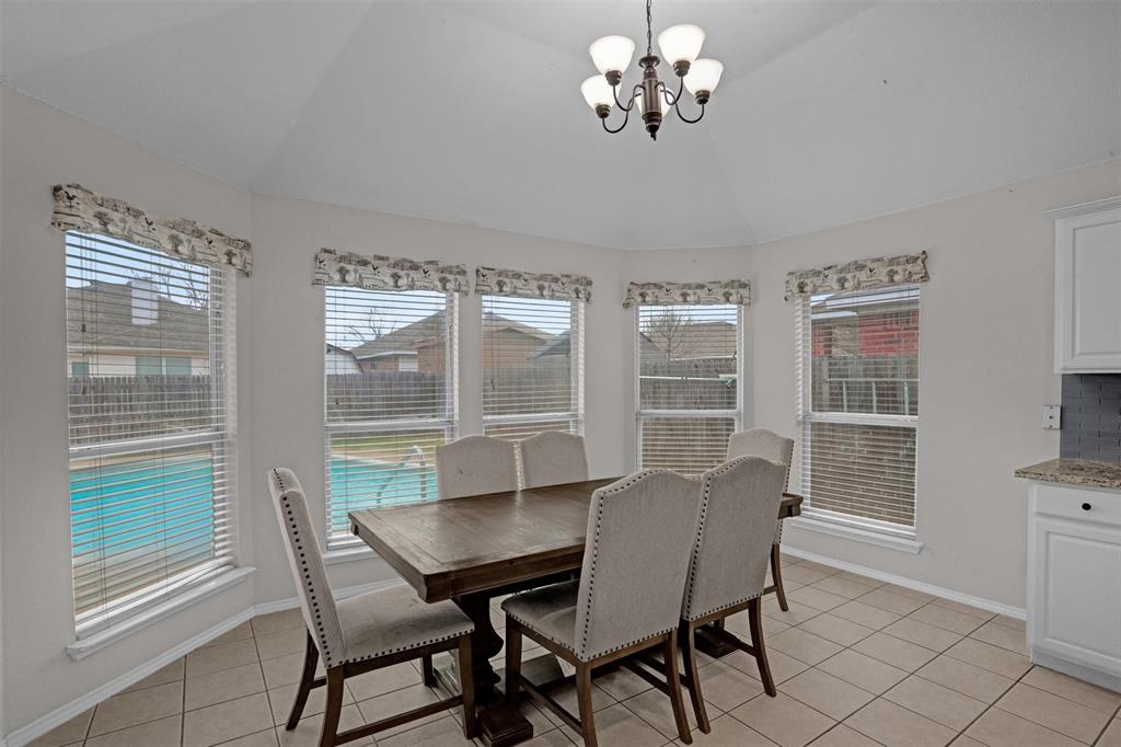 1005 Caleb Street Burleson, TX 76028 - Photo 9 of 31 a view of a dining room with furniture a chandelier and wooden floor