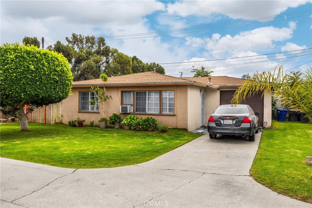 4229 Cogswell Road El Monte, CA 91732 - Photo 5 of 12 a car parked in front of a house with a garden