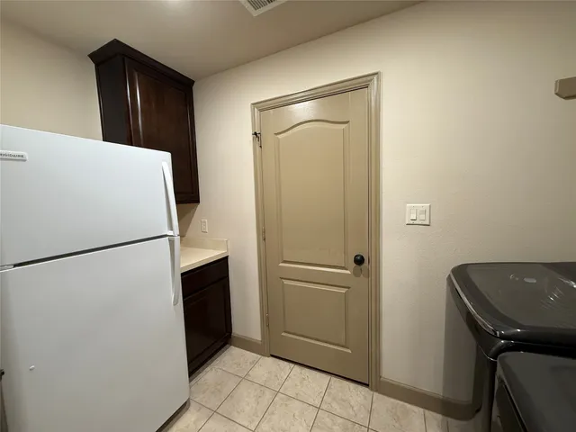 a white refrigerator freezer and a stove sitting inside of a refrigerator