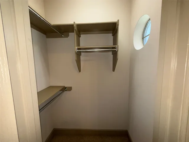 a view of a livingroom with a ceiling fan and window