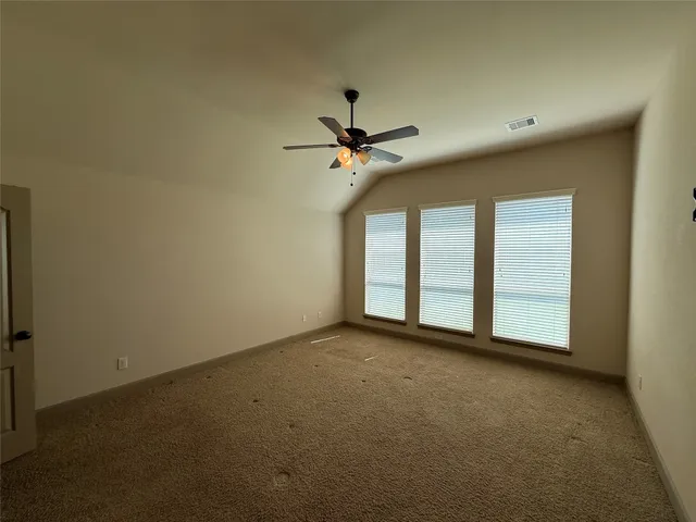 a view of a livingroom with a ceiling fan and window