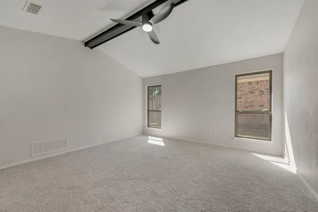 an empty room with windows and closet
