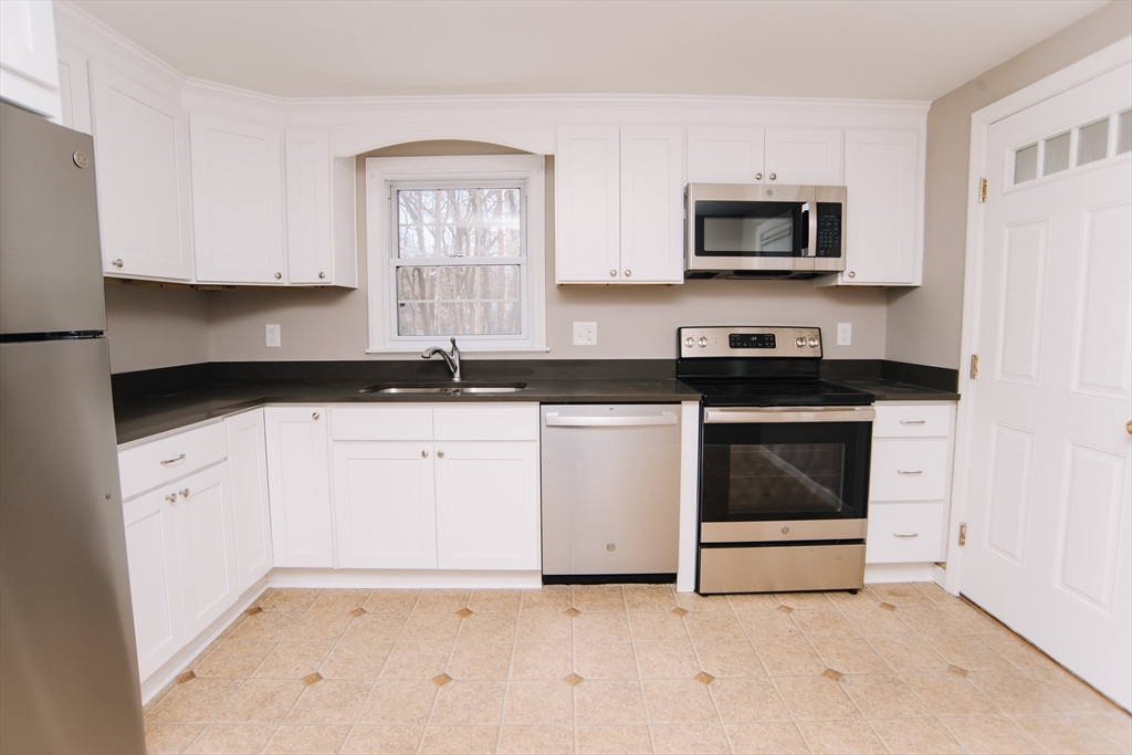 75 Lumae Street Springfield, MA 01119 - Photo 15 of 38 a kitchen with white cabinets stainless steel appliances and sink