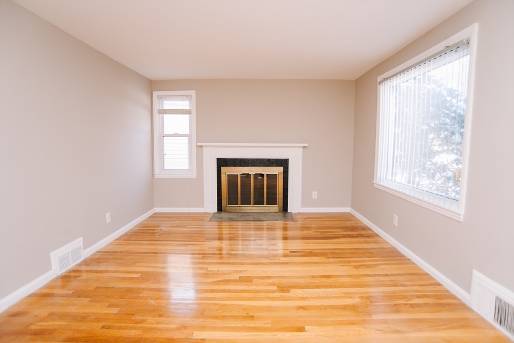 75 Lumae Street Springfield, MA 01119 - Photo 8 of 38 a view of an empty room with a window and wooden floor