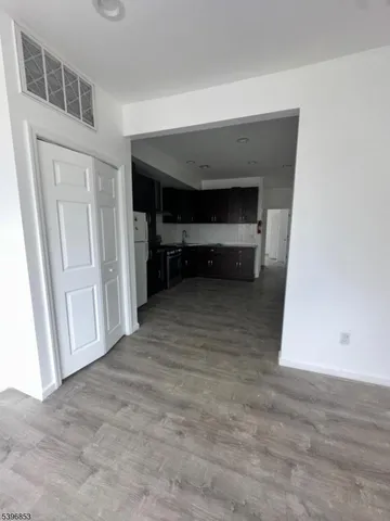 a view of empty room with furniture and closet