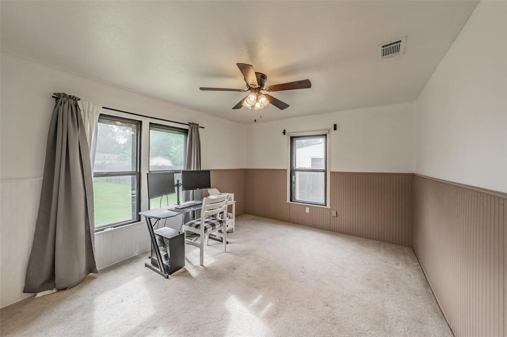 1802 Keneipp Road Carrollton, TX 75006 - Photo 13 of 22 This room features two windows and a ceiling fan, with carpeted flooring and walls with a two-tone finish