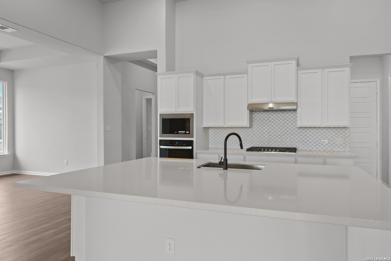 220 Fillmore Falls Cibolo, TX 78108 - Photo 6 of 30 a kitchen with kitchen island a sink appliances and cabinets