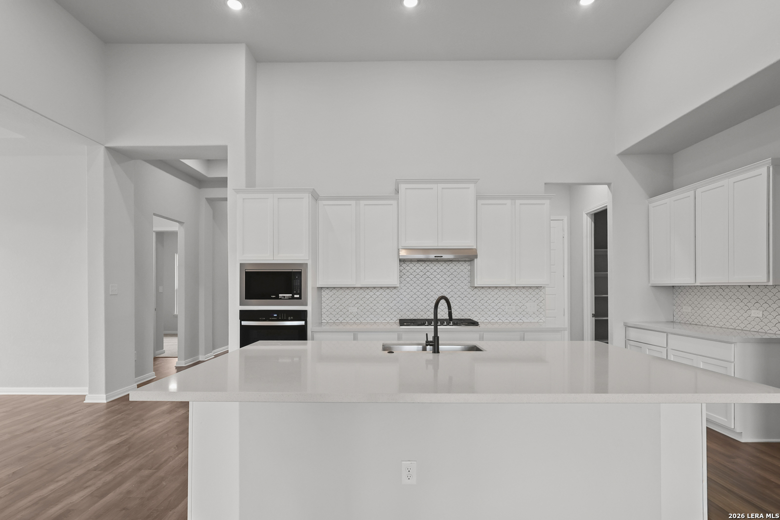 220 Fillmore Falls Cibolo, TX 78108 - Photo 7 of 30 a kitchen with stainless steel appliances a sink a stove a microwave a sink a refrigerator and cabinets