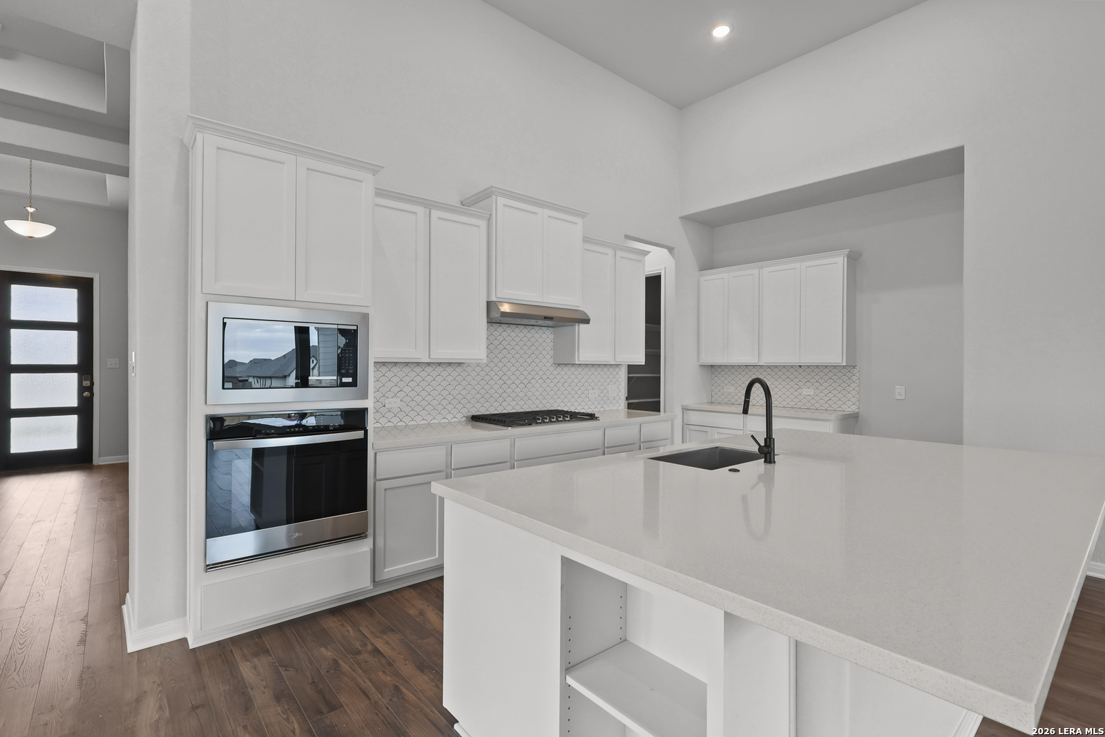 220 Fillmore Falls Cibolo, TX 78108 - Photo 9 of 30 a kitchen with a sink white cabinets and stainless steel appliances