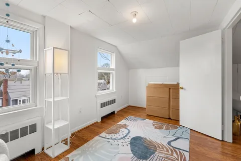 a bedroom with furniture and a window