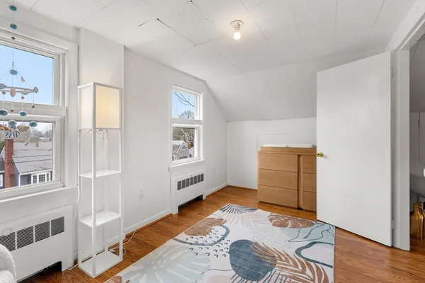 a bedroom with furniture and a window