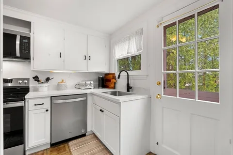 a kitchen with a sink stove and cabinets