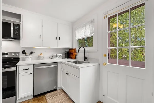 a kitchen with a sink stove and cabinets