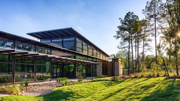a front view of a house with a big yard