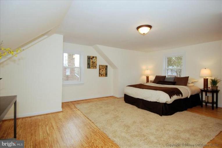10208 Colesville Road Silver Spring, MD 20901 - Photo 8 of 10 a spacious bedroom with a bed and a window