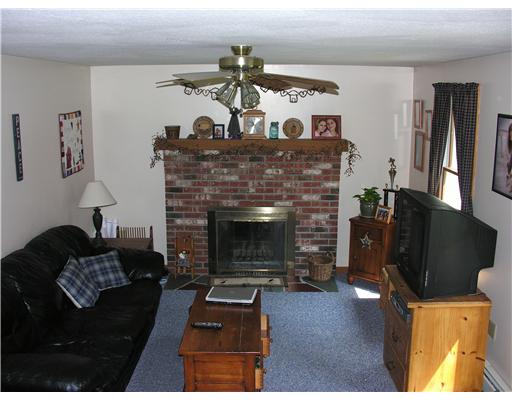 148 East Killingly Road Foster, RI 02825 - Photo 2 of 10 Living Room. Nice sized living room with ceiling fan and brick fireplace.