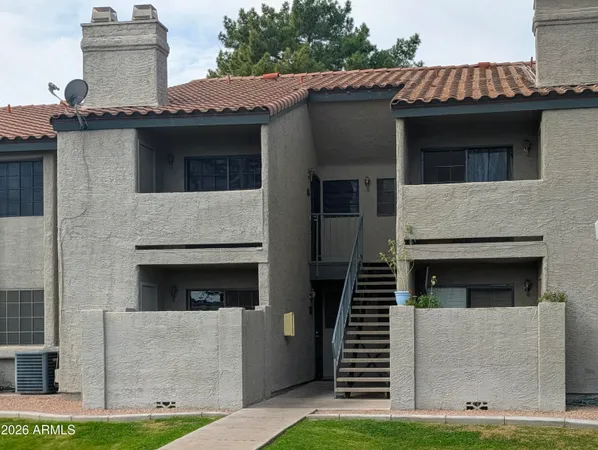 a view of a house with garage and a balcony