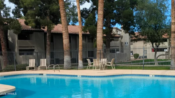 a view of a house with swimming pool and sitting area