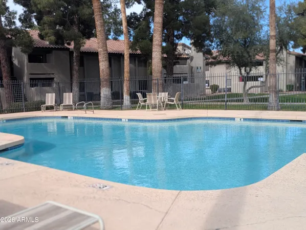 a view of a swimming pool with outdoor seating