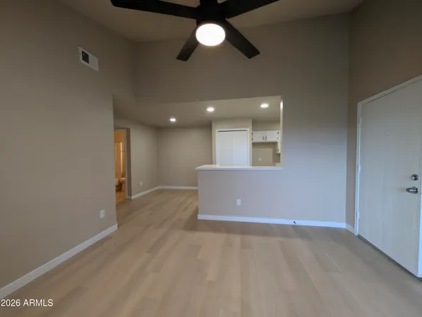 a view of a livingroom with a ceiling fan and window