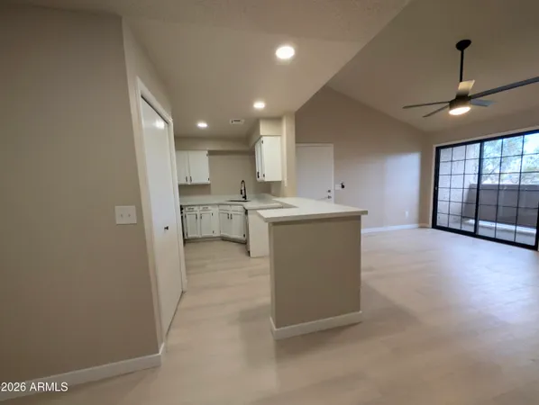 a view of a kitchen with a sink and cabinets