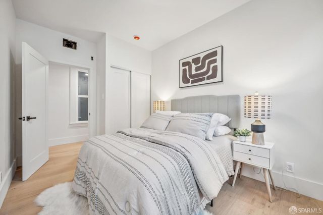 a bedroom with a bed and a lamp