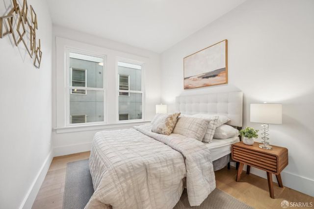 a bedroom with a bed and a potted plant