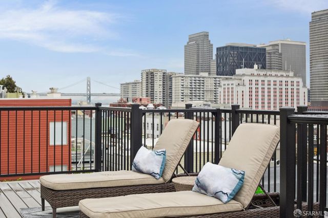 a balcony with table and chairs