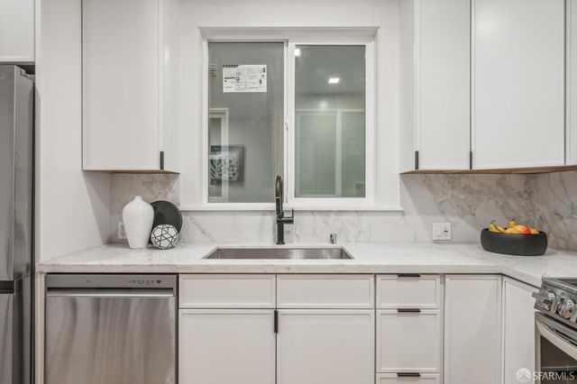 a kitchen with a sink and cabinets