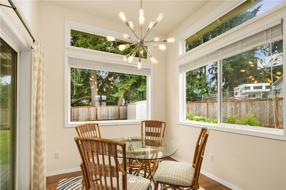 909 Graham Avenue Northeast Renton, WA 98059 - Photo 11 of 32 a view of a dining room with furniture a chandelier and window