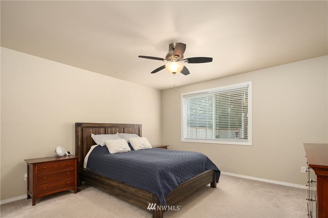 909 Graham Avenue Northeast Renton, WA 98059 - Photo 19 of 32 a bedroom with a bed and window
