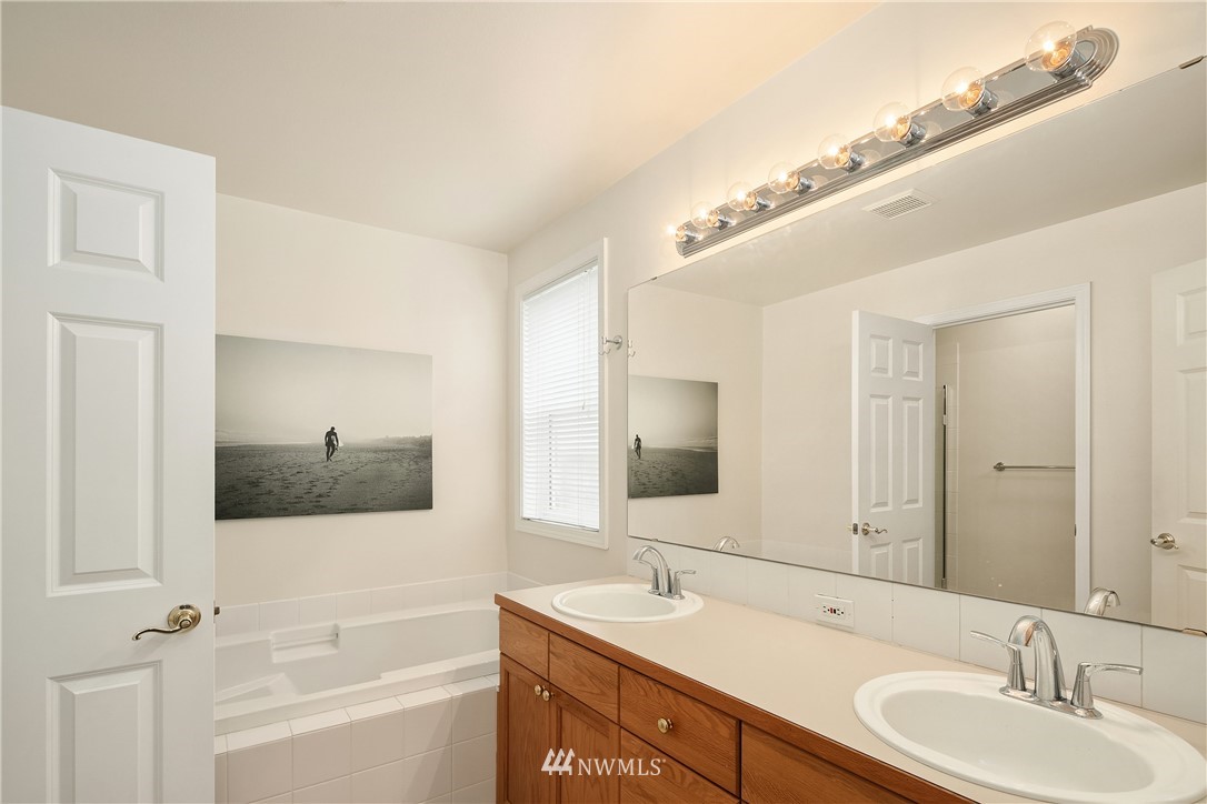 909 Graham Avenue Northeast Renton, WA 98059 - Photo 20 of 32 a bathroom with a double vanity sink and mirror