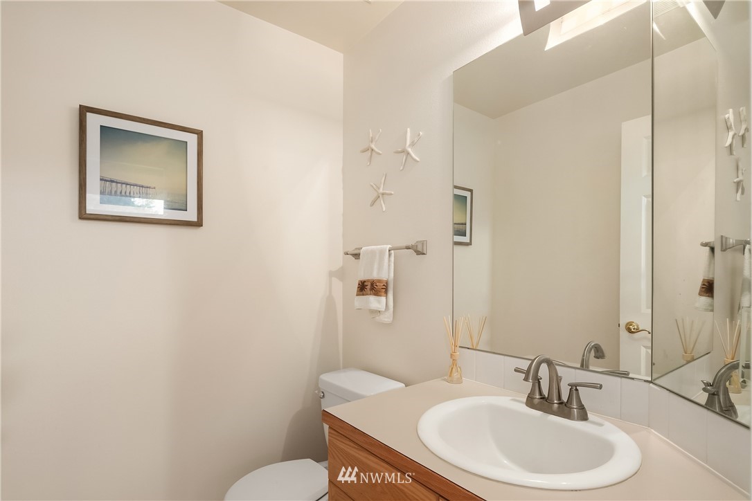 909 Graham Avenue Northeast Renton, WA 98059 - Photo 22 of 32 a bathroom with a sink a toilet and a mirror