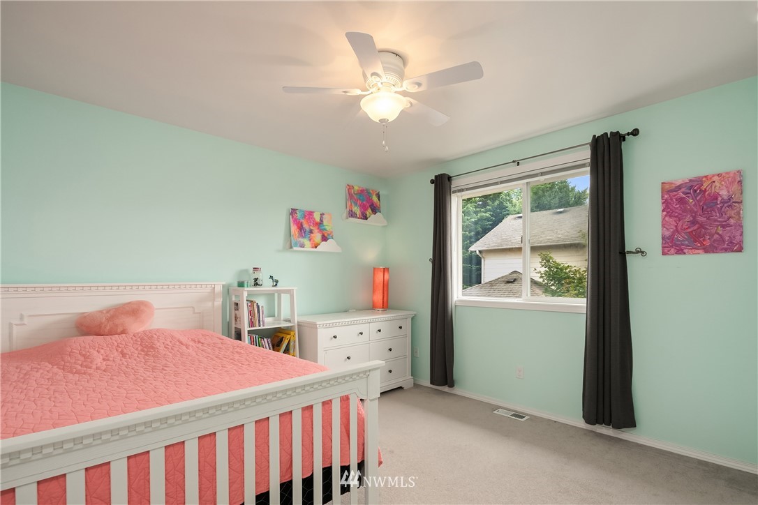 909 Graham Avenue Northeast Renton, WA 98059 - Photo 24 of 32 a bedroom with a bed and a window